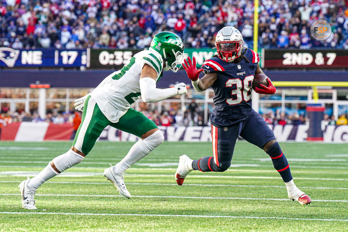 Oct 27, 2024; Foxborough, Massachusetts, USA; New England Patriots running back Rhamondre Stevenson (38) runs the ball against New York Jets cornerback Isaiah Oliver (23) in the second half at Gillette Stadium. Credit: David Butler II-Imagn Images