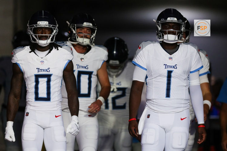 Aug 9, 2025; Tampa, Florida, USA; Tennessee Titans wide receiver Calvin Ridley (0) and quarterback Cameron Ward (1) take the field for warmups before a preseason game against the Tampa Bay Buccaneers at Raymond James Stadium. Credit: Nathan Ray Seebeck-Imagn Images