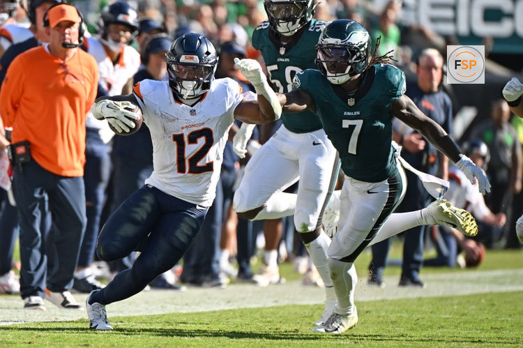 Oct 5, 2025; Philadelphia, Pennsylvania, USA; Denver Broncos running back RJ Harvey (12) runs past Philadelphia Eagles cornerback Kelee Ringo (7) at Lincoln Financial Field. Credit: Eric Hartline-Imagn Images