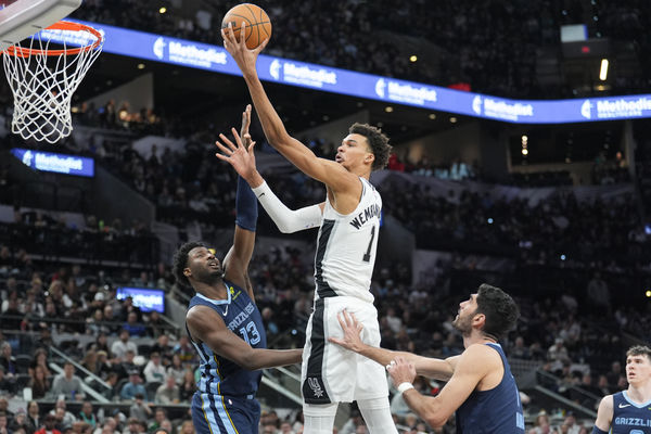 Jan 17, 2025; San Antonio, Texas, USA; San Antonio Spurs center Victor Wembanyama (1) shoots in between Memphis Grizzlies forwards Jaren Jackson Jr. (13) and Santi Aldama (7) in the second half at Frost Bank Center. Mandatory Credit: Daniel Dunn-Imagn Images