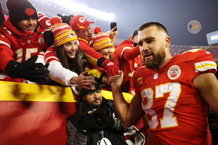 KANSAS CITY, MISSOURI - JANUARY 23: Travis Kelce #87 of the Kansas City Chiefs celebrates with fans after defeating the Buffalo Bills in the AFC Divisional Playoff game at Arrowhead Stadium on January 23, 2022 in Kansas City, Missouri. The Kansas City Chiefs defeated the Buffalo Bills with a score of 42 to 36. (Photo by Jamie Squire/Getty Images)