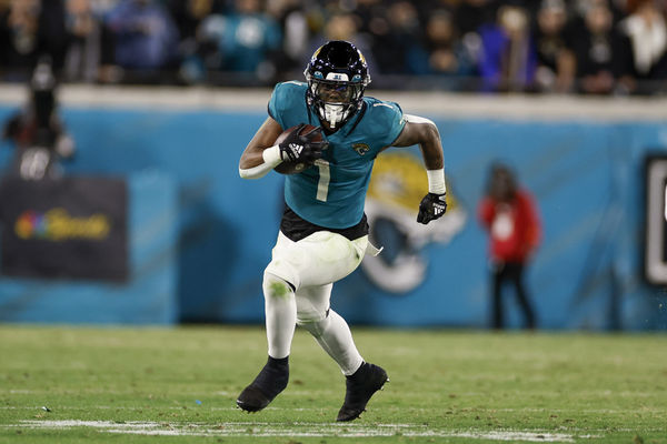 JACKSONVILLE, FL - JANUARY 14:Jacksonville Jaguars running back Travis Etienne Jr. (1) runs with the ball  during the game between the Los Angeles Chargers and the Jacksonville Jaguars on January 14, 2023 at TIAA Bank Field in Jacksonville, Fl. (Photo by David Rosenblum/Icon Sportswire)