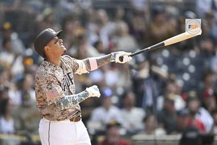May 10, 2026; San Diego, California, USA; San Diego Padres third baseman Manny Machado (13) hits a walk-off sacrifice fly during the tenth inning against the St. Louis Cardinals at Petco Park. Credit: Denis Poroy-Imagn Images