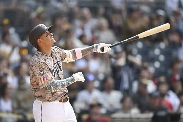 May 10, 2026; San Diego, California, USA; San Diego Padres third baseman Manny Machado (13) hits a walk-off sacrifice fly during the tenth inning against the St. Louis Cardinals at Petco Park. Mandatory Credit: Denis Poroy-Imagn Images