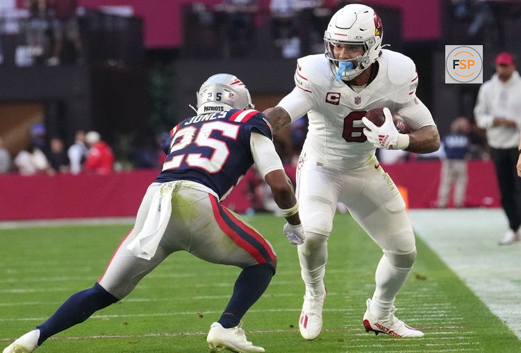 Arizona Cardinals running back James Conner (6) stiff arms New England Patriots cornerback Marcus Jones (25) at State Farm Stadium on Dec. 15, 2024.