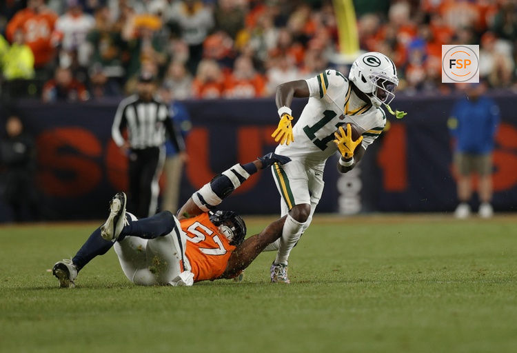 Dec 14, 2025; Denver, Colorado, USA; Green Bay Packers wide receiver Jayden Reed (11) runs for a gain past Denver Broncos linebacker Dre Greenlaw (57) during the fourth quarter at Empower Field at Mile High. Credit: Isaiah J. Downing-Imagn Images