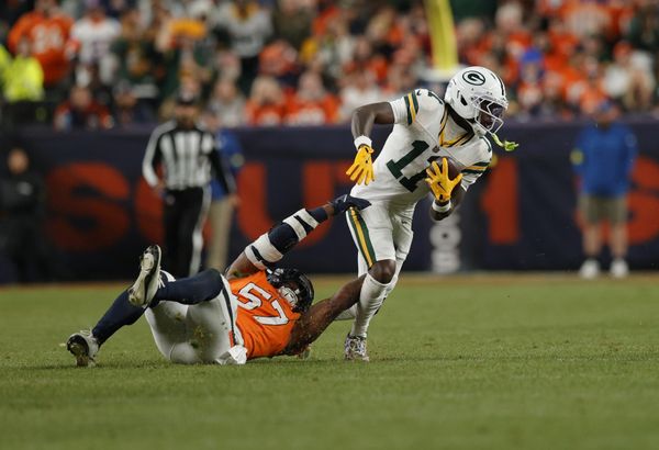 Dec 14, 2025; Denver, Colorado, USA; Green Bay Packers wide receiver Jayden Reed (11) runs for a gain past Denver Broncos linebacker Dre Greenlaw (57) during the fourth quarter at Empower Field at Mile High. Mandatory Credit: Isaiah J. Downing-Imagn Images