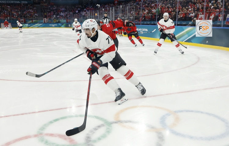 Feb 13, 2026; Milan, Italy; Jonas Siegenthaler of Switzerland in action with Macklin Celebrini of Canada in men's ice hockey group A play during the Milano Cortina 2026 Olympic Winter Games at Milano Santagiulia Ice Hockey Arena. Credit: Geoff Burke-Imagn Images