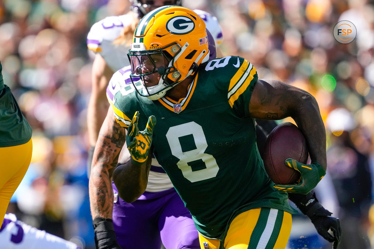 Sep 29, 2024; Green Bay, Wisconsin, USA;  Green Bay Packers running back Josh Jacobs (8) rushes with the football during the first quarter against the Minnesota Vikings at Lambeau Field. Credit: Jeff Hanisch-Imagn Images