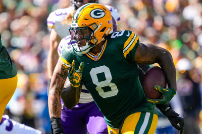 Sep 29, 2024; Green Bay, Wisconsin, USA;  Green Bay Packers running back Josh Jacobs (8) rushes with the football during the first quarter against the Minnesota Vikings at Lambeau Field. Mandatory Credit: Jeff Hanisch-Imagn Images