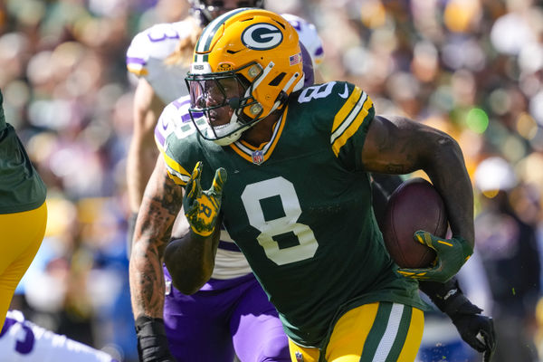 Sep 29, 2024; Green Bay, Wisconsin, USA;  Green Bay Packers running back Josh Jacobs (8) rushes with the football during the first quarter against the Minnesota Vikings at Lambeau Field. Mandatory Credit: Jeff Hanisch-Imagn Images