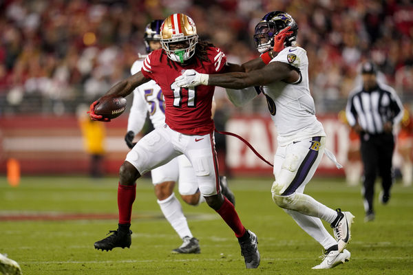 Dec 25, 2023; Santa Clara, California, USA; San Francisco 49ers wide receiver Brandon Aiyuk (11) runs with the ball next to Baltimore Ravens linebacker Patrick Queen (6) in the fourth quarter at Levi's Stadium. Mandatory Credit: Cary Edmondson-USA TODAY Sports