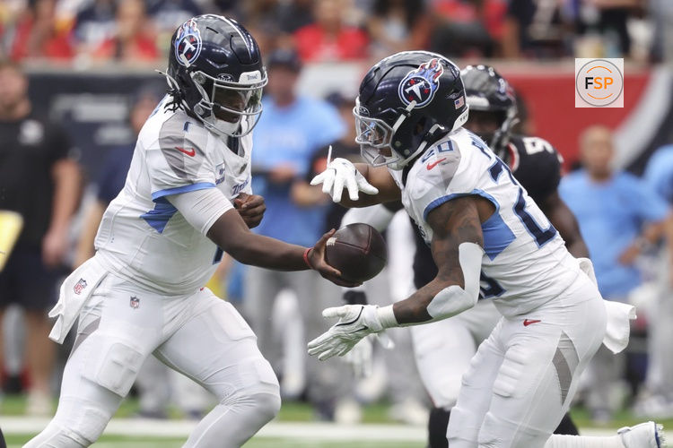 Sep 28, 2025; Houston, Texas, USA; Tennessee Titans quarterback Cam Ward (1) hands off to running back Tony Pollard (20) during the third quarter against the Houston Texans at NRG Stadium. Credit: Troy Taormina-Imagn Images