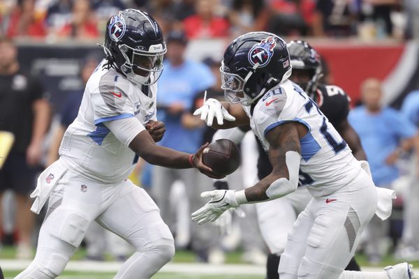 Sep 28, 2025; Houston, Texas, USA; Tennessee Titans quarterback Cam Ward (1) hands off to running back Tony Pollard (20) during the third quarter against the Houston Texans at NRG Stadium. Mandatory Credit: Troy Taormina-Imagn Images