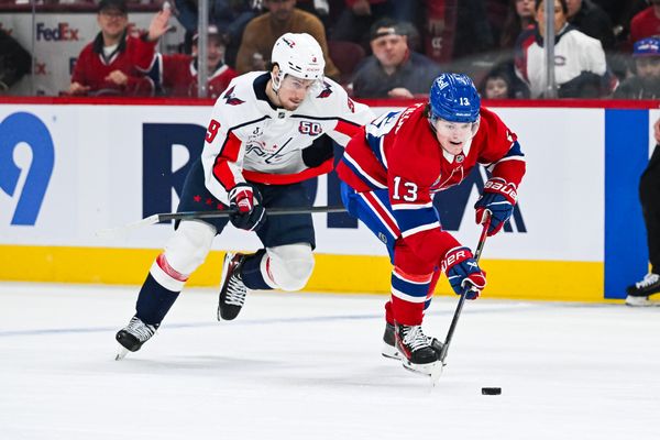 Apr 27, 2025; Montreal, Quebec, CAN; Montreal Canadiens right wing Cole Caufield (13) plays the puck against Washington Capitals right wing Ryan Leonard (9) during the first period in game four of the first round of the 2025 Stanley Cup Playoffs at Bell Centre. Mandatory Credit: David Kirouac-Imagn Images