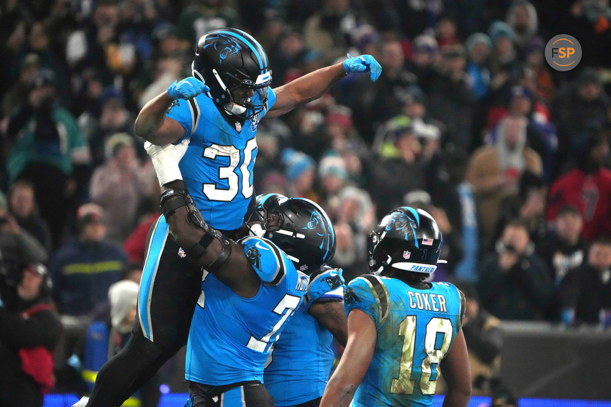 Nov 10, 2024; Munich, Germany; Carolina Panthers running back Chuba Hubbard (30) celebrates with offensive tackle Taylor Moton (72) and wide receiver Jalen Coker (18) after scoring on a 1-yard touchdown run against the New York Giants in the second half during the 2024 NFL Munich Game at Allianz Arena. Credit: Kirby Lee-Imagn Images