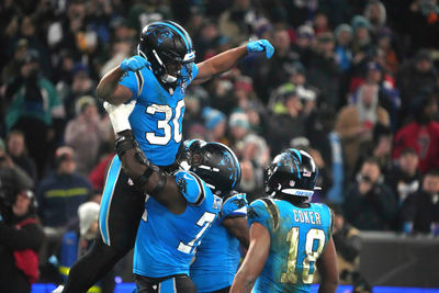 Nov 10, 2024; Munich, Germany; Carolina Panthers running back Chuba Hubbard (30) celebrates with offensive tackle Taylor Moton (72) and wide receiver Jalen Coker (18) after scoring on a 1-yard touchdown run against the New York Giants in the second half during the 2024 NFL Munich Game at Allianz Arena. Mandatory Credit: Kirby Lee-Imagn Images