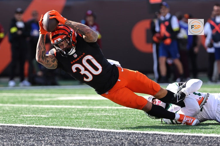 Oct 26, 2025; Cincinnati, Ohio, USA; Cincinnati Bengals running back Chase Brown (30) scores a touchdown during the second quarter against the New York Jets at Paycor Stadium. Credit: Joseph Maiorana-Imagn Images