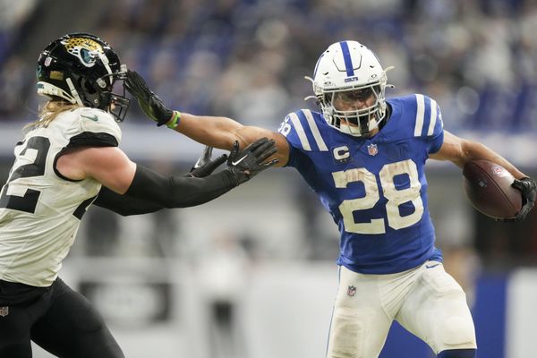 Jan 5, 2025; Indianapolis, Indiana, USA; Indianapolis Colts running back Jonathan Taylor (28) pushes off Jacksonville Jaguars cornerback De'Antre Prince (24) as he rushes the ball during a game against the Jacksonville Jaguar at Lucas Oil Stadium. Mandatory Credit: Grace Hollars/USA TODAY Network via Imagn Images