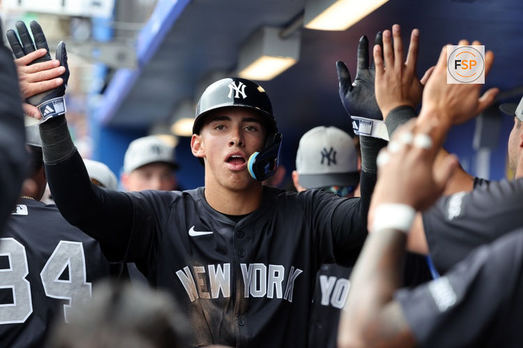 Feb 22, 2025; Dunedin, Florida, USA;  New York Yankees shortstop George Lombard Jr. (96)  is congratulated after he scored a run during the sixth inning against the Toronto Blue Jays at TD Ballpark. Credit: Kim Klement Neitzel-Imagn Images
