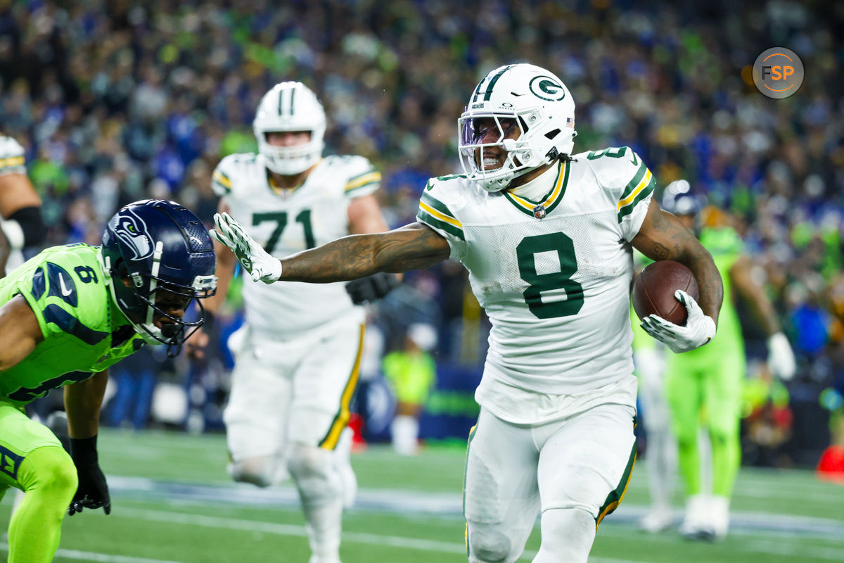 Dec 15, 2024; Seattle, Washington, USA; Green Bay Packers running back Josh Jacobs (8) rushes against the Seattle Seahawks during the first quarter at Lumen Field. Credit: Joe Nicholson-Imagn Images