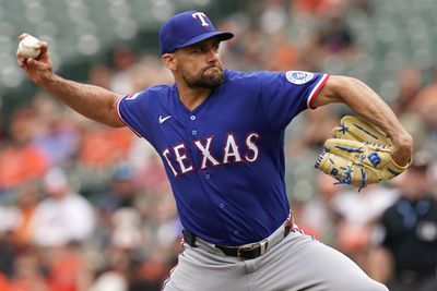 Apr 1, 2026; Baltimore, Maryland, USA; Texas Rangers pitcher Nathan Eovaldi (left) delivers during the first inning against the Baltimore Orioles at Oriole Park at Camden Yards. Mandatory Credit: Mitch Stringer-Imagn Images
