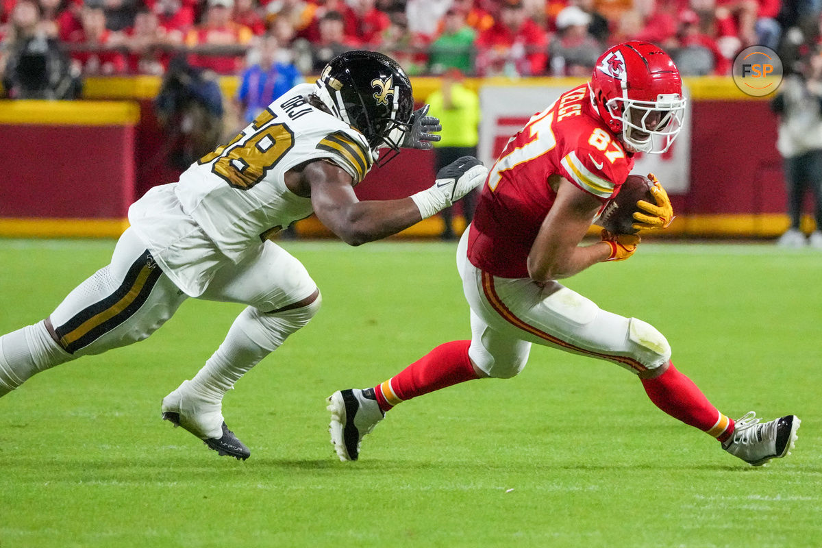 Oct 7, 2024; Kansas City, Missouri, USA; Kansas City Chiefs tight end Travis Kelce (87) runs the ball as New Orleans Saints linebacker Anfernee Orji (58) attempts the tackle during the first half at GEHA Field at Arrowhead Stadium. Credit: Denny Medley-Imagn Images