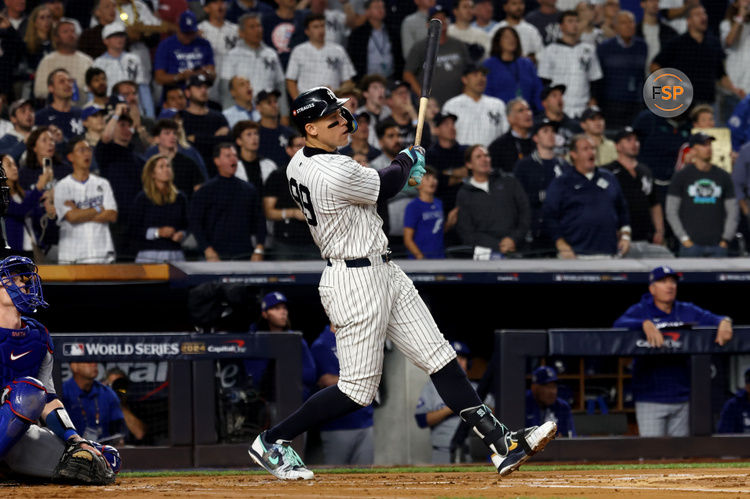 Oct 30, 2024; New York, New York, USA; New York Yankees outfielder Aaron Judge (99) hits a two-run home run during the first inning against the Los Angeles Dodgers in game five of the 2024 MLB World Series at Yankee Stadium. Credit: Vincent Carchietta-Imagn Images