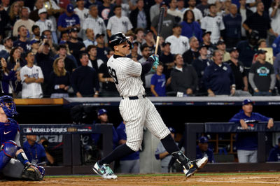 Oct 30, 2024; New York, New York, USA; New York Yankees outfielder Aaron Judge (99) hits a two-run home run during the first inning against the Los Angeles Dodgers in game five of the 2024 MLB World Series at Yankee Stadium. Mandatory Credit: Vincent Carchietta-Imagn Images