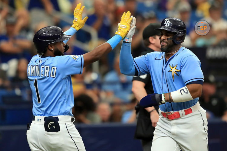 ST. PETERSBURG, FL - September 24: Tampa Bay Rays Infield Junior Caminero (1) congratulates First Baseman Yandy Diaz (2) on scoring during the MLB regular season game between the Toronto Blue Jays and the Tampa Bay Rays on August 12, 2023, at Tropicana Field in St. Petersburg, FL. (Photo by Cliff Welch/Icon Sportswire)