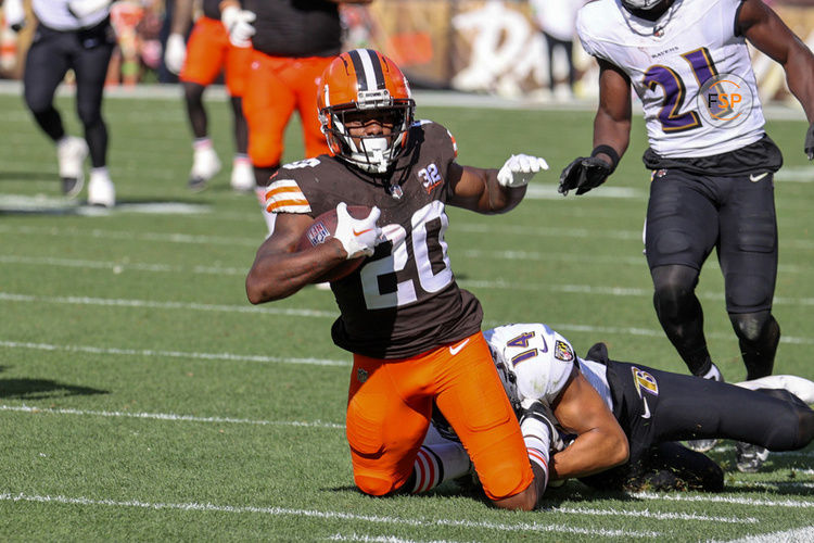 CLEVELAND, OH - OCTOBER 01: Cleveland Browns running back Pierre Strong Jr. (20) is tackled by Baltimore Ravens safety Kyle Hamilton (14) during the fourth quarter of the National Football League game between the Baltimore Ravens and Cleveland Browns on October 1, 2023, at Cleveland Browns Stadium in Cleveland, OH. (Photo by Frank Jansky/Icon Sportswire)