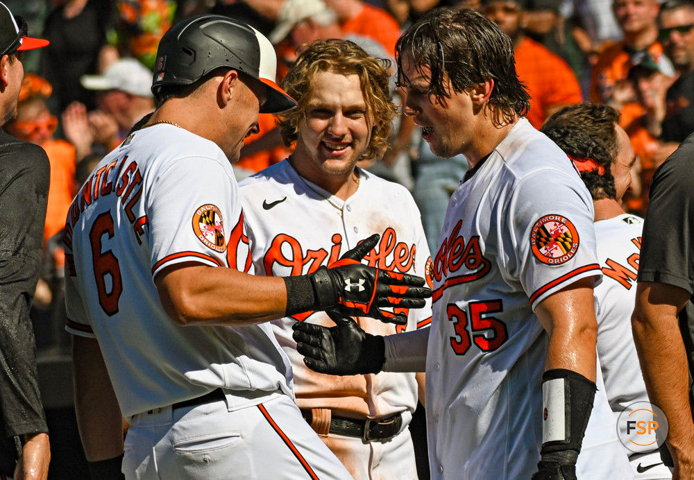 BALTIMORE, MD - April 13: Baltimore Orioles designated hitter Ryan Mountcastle (6) congratulates catcher Adley Rutschman (35) after his walk off home run as third baseman Gunnar Henderson (2) looks on during the Oakland Athletics versus the Baltimore Orioles on April 13, 2023 at Oriole Park at Camden Yards in Baltimore, MD.  (Photo by Mark Goldman/Icon Sportswire)