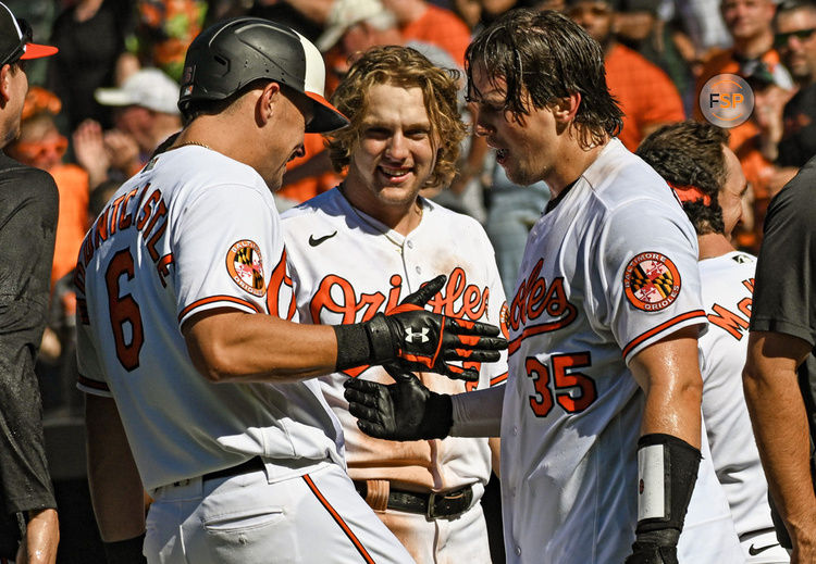 BALTIMORE, MD - April 13: Baltimore Orioles designated hitter Ryan Mountcastle (6) congratulates catcher Adley Rutschman (35) after his walk off home run as third baseman Gunnar Henderson (2) looks on during the Oakland Athletics versus the Baltimore Orioles on April 13, 2023 at Oriole Park at Camden Yards in Baltimore, MD.  (Photo by Mark Goldman/Icon Sportswire)