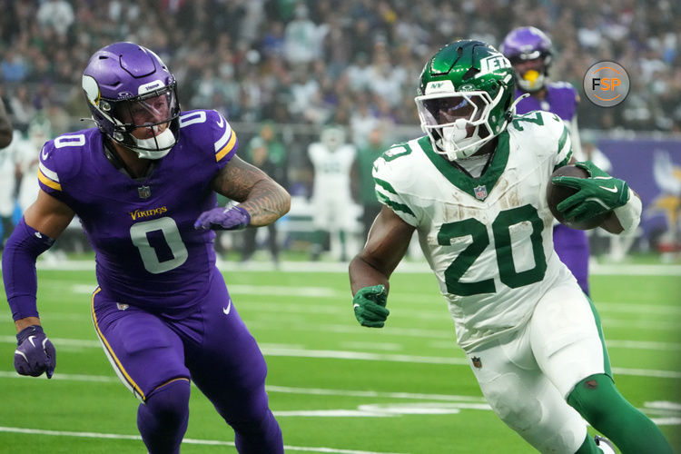 Oct 6, 2024; London, United Kingdom; New York Jets running back Breece Hall (20) carries the ball against Minnesota Vikings linebacker Ivan Pace Jr. (0) in the second half at Tottenham Hotspur Stadium. Credit: Kirby Lee-Imagn Images