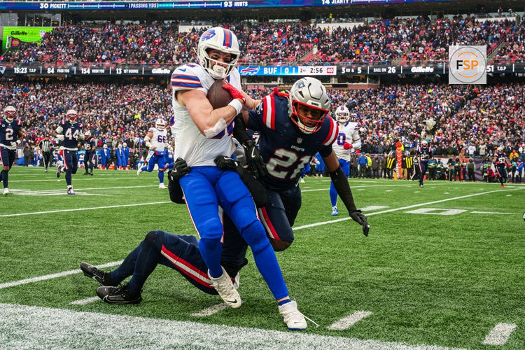 Dec 14, 2025; Foxborough, Massachusetts, USA; Buffalo Bills tight end Dawson Knox (88) runs the ball against New England Patriots safety Jaylinn Hawkins (21) in the first quarter at Gillette Stadium. Credit: David Butler II-Imagn Images