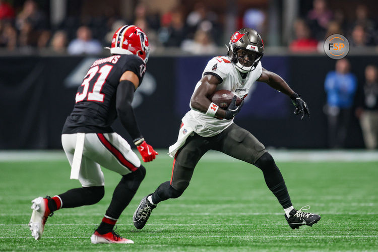 Oct 3, 2024; Atlanta, Georgia, USA; Tampa Bay Buccaneers wide receiver Chris Godwin (14) is pursued by Atlanta Falcons safety Justin Simmons (31) in the first quarter at Mercedes-Benz Stadium. Credit: Brett Davis-Imagn Images