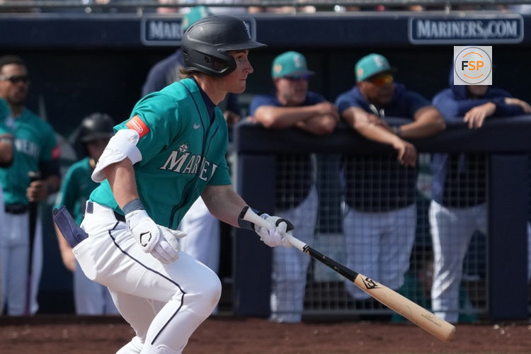 Feb 26, 2026; Peoria, Arizona, USA; Seattle Mariners shortstop Colt Emerson (85) hits a single against the Cleveland Guardians in the second inning at Peoria Sports Complex. Credit: Rick Scuteri-Imagn Images
