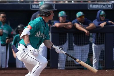 Feb 26, 2026; Peoria, Arizona, USA; Seattle Mariners shortstop Colt Emerson (85) hits a single against the Cleveland Guardians in the second inning at Peoria Sports Complex. Mandatory Credit: Rick Scuteri-Imagn Images