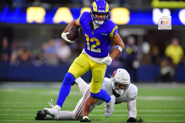 Jan 4, 2026; Inglewood, California, USA;  Los Angeles Rams wide receiver Puka Nacua (12) runs after the catch as Arizona Cardinals linebacker Cody Simon (50) defends during the second half at SoFi Stadium. Credit: Gary A. Vasquez-Imagn Images