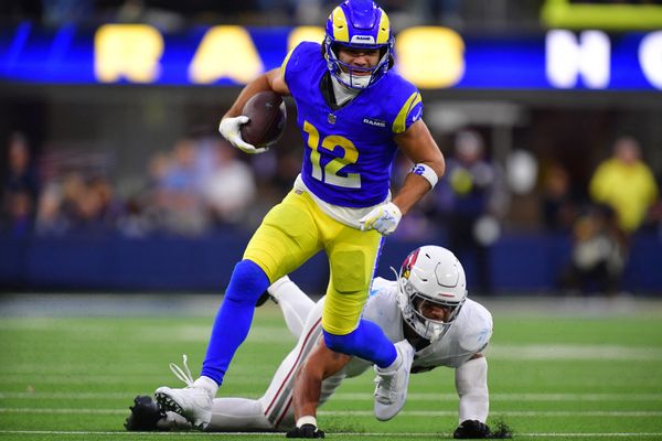 Jan 4, 2026; Inglewood, California, USA;  Los Angeles Rams wide receiver Puka Nacua (12) runs after the catch as Arizona Cardinals linebacker Cody Simon (50) defends during the second half at SoFi Stadium. Mandatory Credit: Gary A. Vasquez-Imagn Images