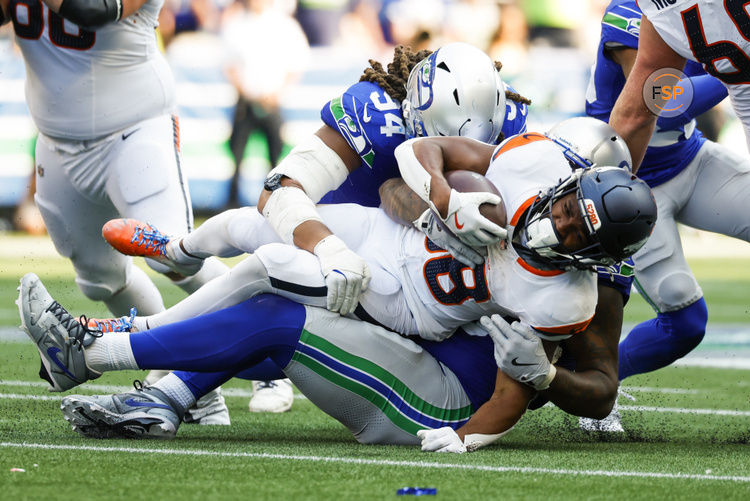 Sep 8, 2024; Seattle, Washington, USA; Denver Broncos running back Jaleel McLaughlin (38) is tackled or a loss by Seattle Seahawks defensive end Mike Morris (94) during the fourth quarter at Lumen Field. Credit: Joe Nicholson-Imagn Images