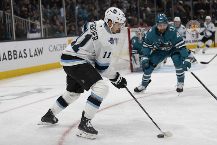 Dec 14, 2024; San Jose, California, USA;  Utah Hockey Club right wing Dylan Guenther (11) controls the puck during the first period against the San Jose Sharks at SAP Center at San Jose. Credit: Stan Szeto-Imagn Images