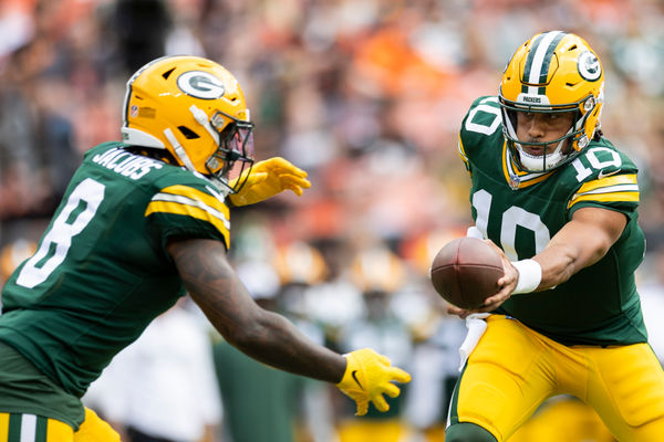 Aug 10, 2024; Cleveland, Ohio, USA; Green Bay Packers quarterback Jordan Love (10) hand the ball off to running back Josh Jacobs (8) during the first quarter against the Cleveland Browns at Cleveland Browns Stadium. Mandatory Credit: Scott Galvin-USA TODAY Sports