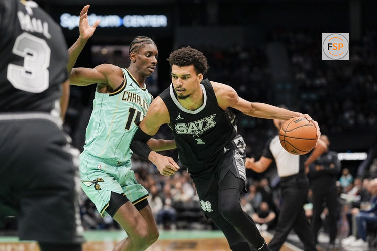 Feb 7, 2025; Charlotte, North Carolina, USA; San Antonio Spurs center Victor Wembanyama (1) goes to the basket against Charlotte Hornets forward Moussa Diabate (14) during the second half at Spectrum Center. Credit: Jim Dedmon-Imagn Images
