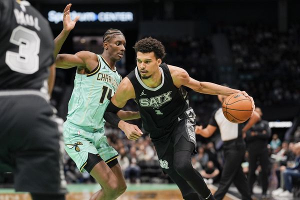 Feb 7, 2025; Charlotte, North Carolina, USA; San Antonio Spurs center Victor Wembanyama (1) goes to the basket against Charlotte Hornets forward Moussa Diabate (14) during the second half at Spectrum Center. Mandatory Credit: Jim Dedmon-Imagn Images