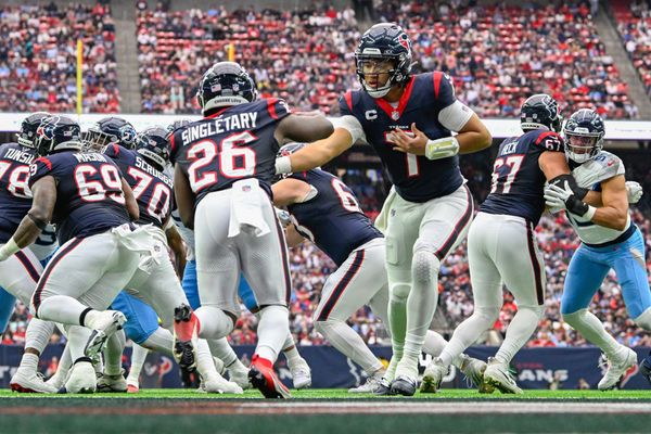 HOUSTON, TX - DECEMBER 31: Houston Texans quarterback C.J. Stroud (7) hands the ball off to Houston Texans running back Devin Singletary (26) during the football game between the Tennessee Titans and Houston Texans at NRG Stadium on December 31, 2023 in Houston, Texas. (Photo by Ken Murray/Icon Sportswire)