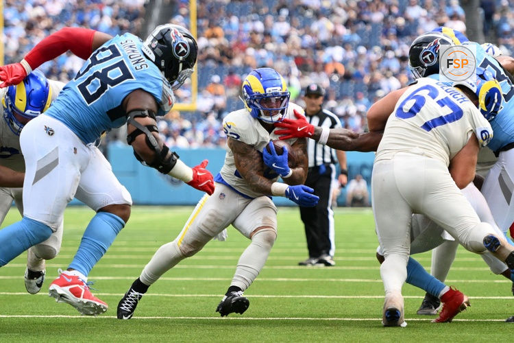 Sep 14, 2025; Nashville, Tennessee, USA; Los Angeles Rams running back Blake Corum (22) rushes the ball against the Tennessee Titans during the second half at Nissan Stadium. Credit: Steve Roberts-Imagn Images