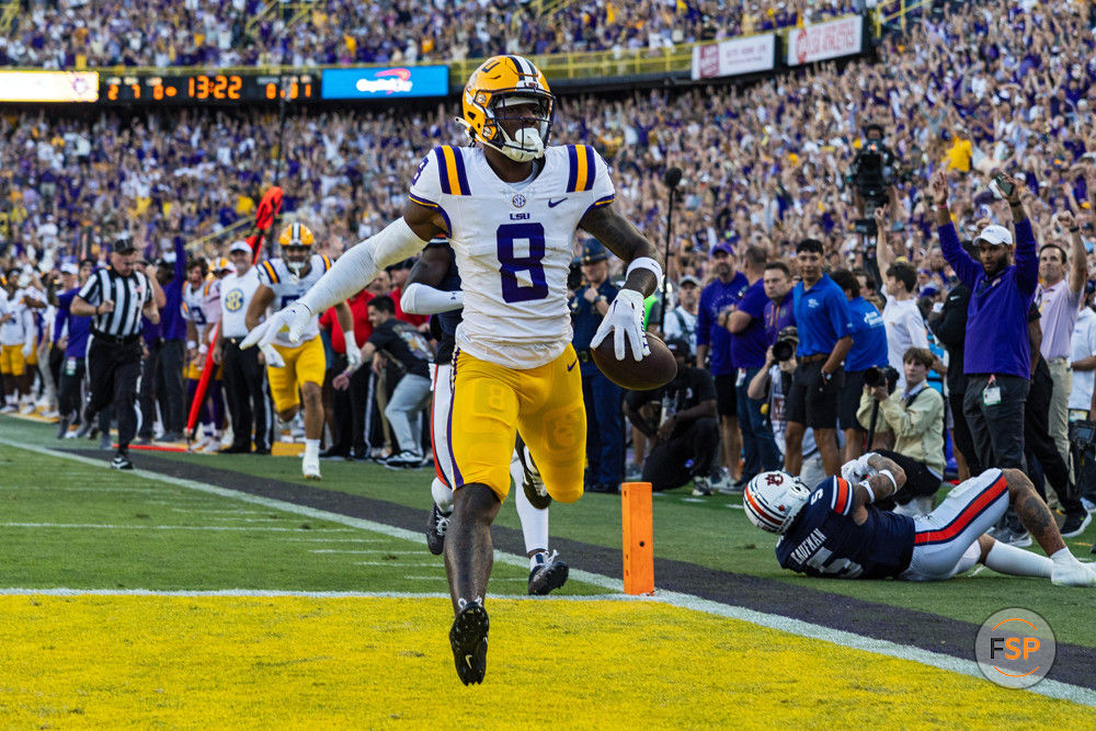 BATON ROUGE, LA - OCTOBER 14: LSU Tigers wide receiver Malik Nabers (8) scores a touchdown during a game between the LSU Tigers and the Auburn Tigers on October 14, 2023, at Tiger Stadium in Baton Rouge, Louisiana. (Photo by John Korduner/Icon Sportswire)