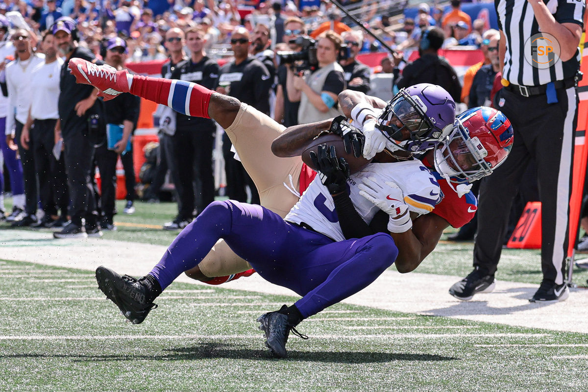 Sep 8, 2024; East Rutherford, New Jersey, USA; Minnesota Vikings wide receiver Jordan Addison (3) is tackled by New York Giants cornerback Dru Phillips (22) during the first half at MetLife Stadium. Credit: Vincent Carchietta-Imagn Images