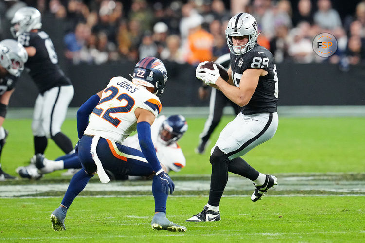 Nov 24, 2024; Paradise, Nevada, USA; Las Vegas Raiders tight end Brock Bowers (89) looks to evade the tackle of Denver Broncos safety Brandon Jones (22) during the fourth quarter at Allegiant Stadium. Credit: Stephen R. Sylvanie-Imagn Images